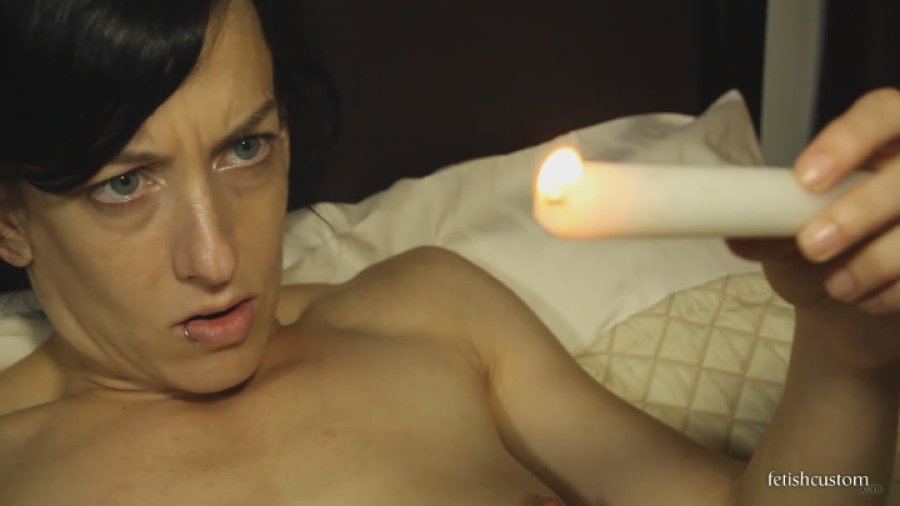 Elise Graves drips wax into her bellybutton